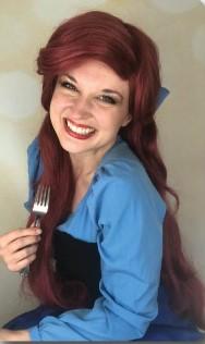 a woman with red hair holding a fork