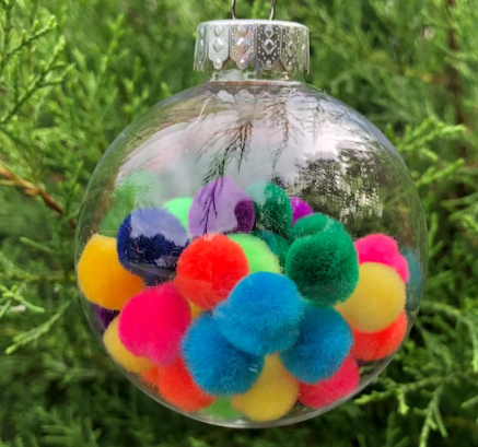 plastic ornament filled with colorful pompoms