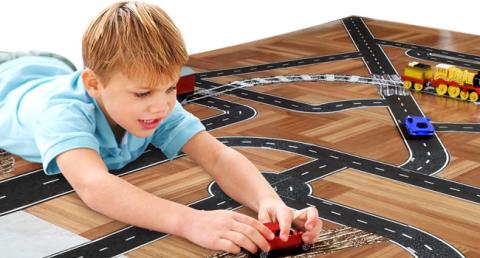 child playing with toy car