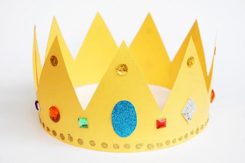 yellow paper crown with multicolor gems and paper cutouts