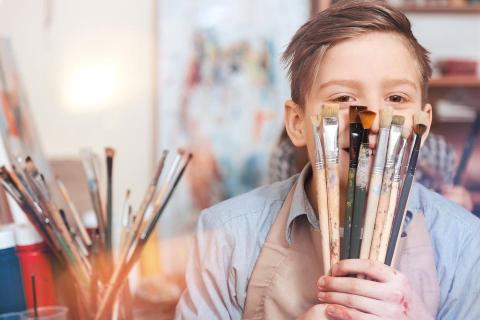 teen with paintbrushes