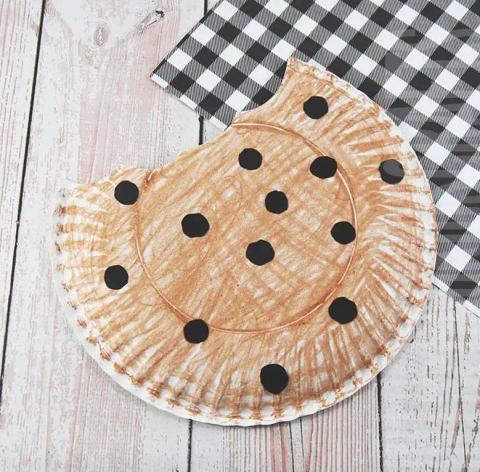 Paper plate colored brown with brown dots to look like a cookie