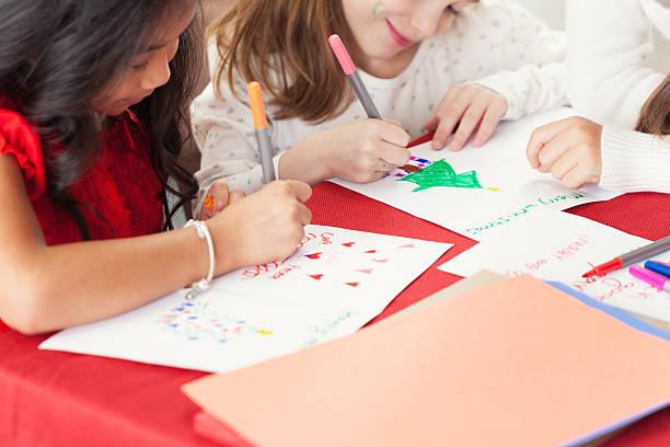 Kids writing cards and using creative supplies.