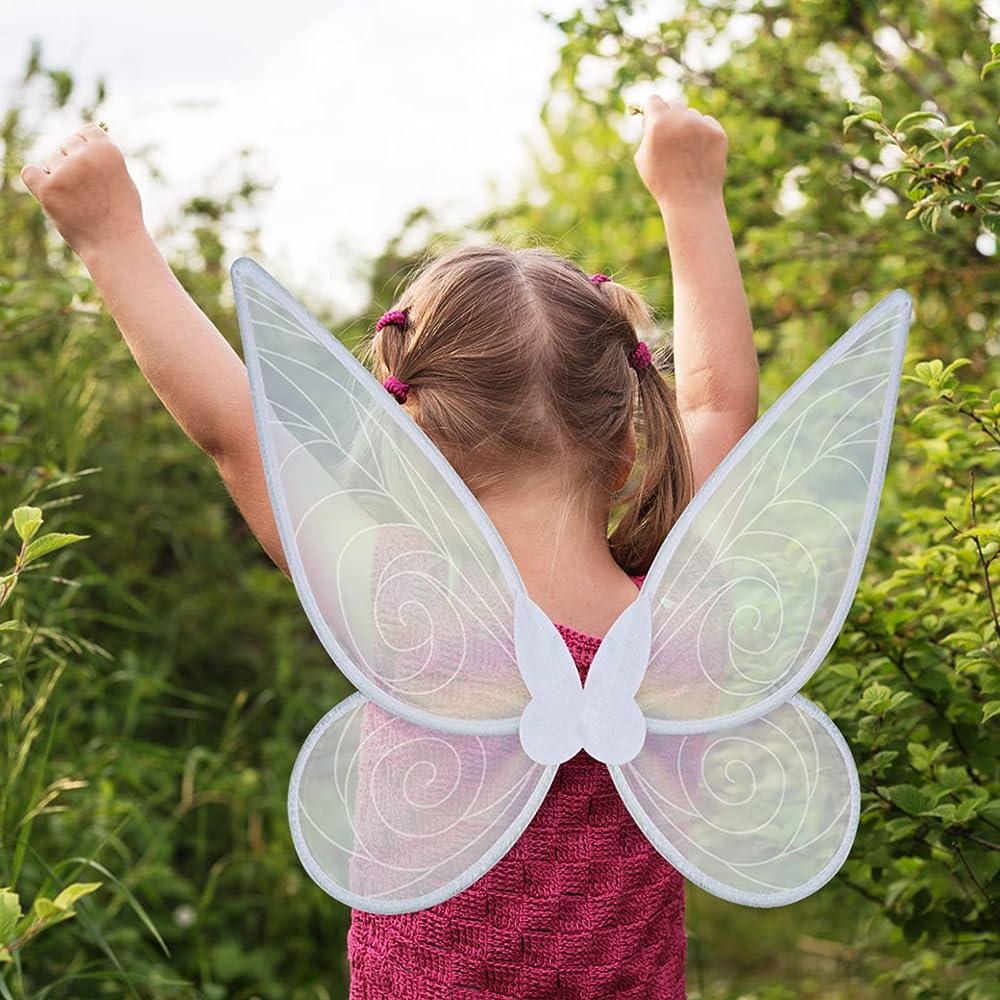 White child facing away from the camera with her arms in the air and white fairy wings on her back