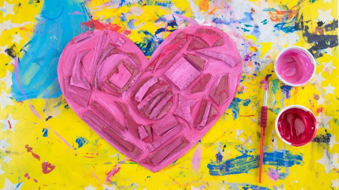 pink painted heart on messy yellow background