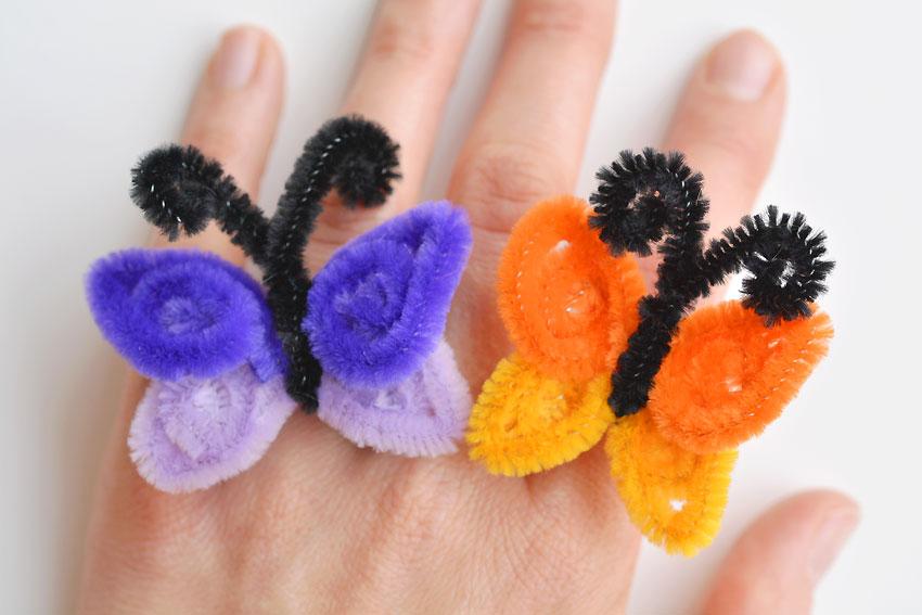 Hand decorated with two butterflies made out of colorful, fuzzy pipe cleaners.