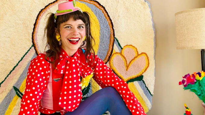 female clown laughing with small hat