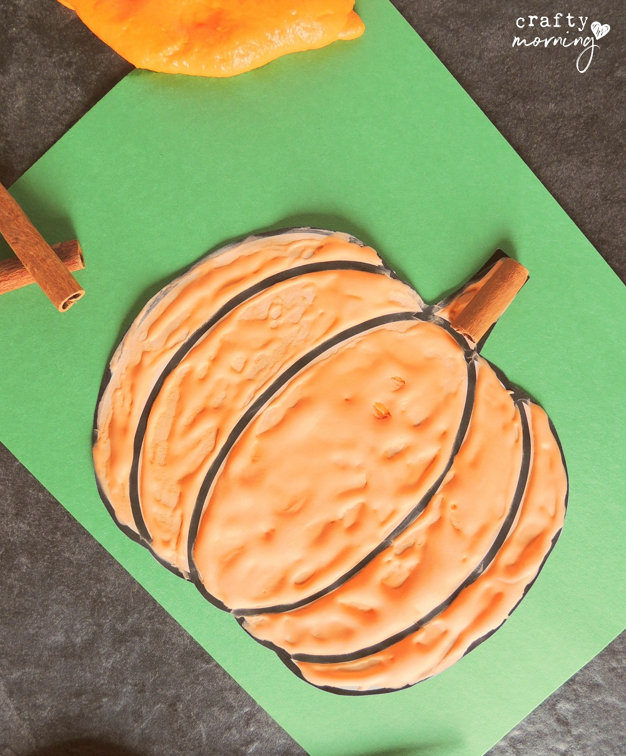 puffy paint pumpkin with cinnamon stem on green paper